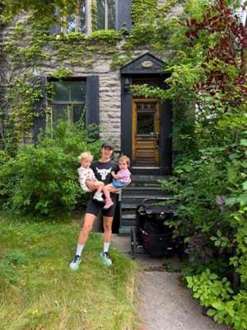 A family moment outside a garden cabin