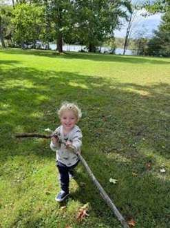 A child exploring a grassy park